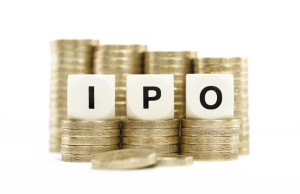 IPO (Initial Public Offering) on coin stacks with white backgrou