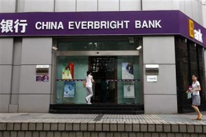 Passers-by walk past a branch of China Everbright Bank in Shanghai in this July 26, 2010 file photo.  REUTERS/Aly Song