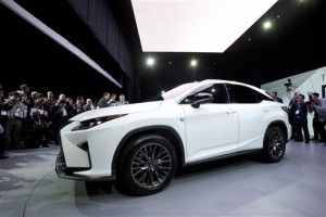 FILE - In this April 1, 2015, file photo, the 2016 Lexus RX is introduced at the New York International Auto Show, in New York. Automakers reported December and full-year sales Tuesday, Jan. 5, 2016. (AP Photo/Mark Lennihan, File)