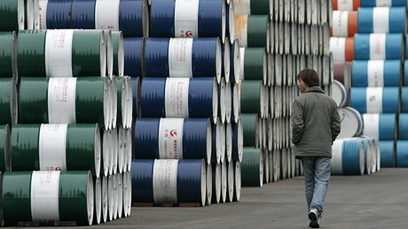 A man walks past a storage area for oil barrels in Shanghai January 20, 2007. China will delay reporting how far short it fell on official energy efficiency targets until it has tightened up the system used to calculate consumption, the official Xinhua agency said. REUTERS/Aly Song (CHINA) - RTR1LE0U