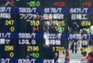 Pedestrians are reflected on an electronic stock quotation board at the window of a securities company in Tokyo on April 8, 2016.
Tokyo stocks fell morning trade on April 8 as market heavyweight Fast Retailing, operator of the Uniqlo clothing chain, plunged more than 11 percent after forecasting a big decline in annual profit. / AFP / TOSHIFUMI KITAMURA        (Photo credit should read TOSHIFUMI KITAMURA/AFP/Getty Images)