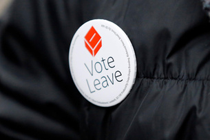 A Pro-Brexit campaigner hands out leaflets at Liverpool Street station in London, Wednesday, March 23, 2016. With less than three months to go until a June 23 referendum, Britain's anti-EU campaigners are bitterly divided, with two rival camps battling over which will be the standard-bearer in the campaign, and over how to win the historic vote. (AP Photo/Frank Augstein)