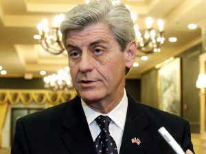 Gov. Phil Bryant tells reporters he favors says some sort of limits on gubernatorial pardon powers as he walks to address members of the Mississippi Hospital Association Tuesday, Jan. 17, 2012 in Jackson, Miss. Bryant says he might favor a constitutional amendment that would allow a governor to single-handedly grant pardons only in cases in which there's clear evidence of innocence. (AP Photo/Rogelio V. Solis)