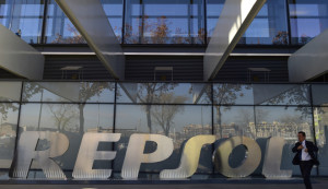 A man walks past the headquarters of Spanish oil company Repsol in Madrid on December 16, 2014. Spanish oil giant Repsol said on December 16, 2014 it has agreed to buy its struggling Canadian rival Talisman for $8.3 billion (6.6 billion euros), a deal that will extend its global reach. Under the deal, which was approved by Repsol's board, the Spanish firm will also assume Talisman's debt of $4.7 billion, Repsol said in a statement.
AFP PHOTO / PIERRE-PHILIPPE MARCOU        (Photo credit should read PIERRE-PHILIPPE MARCOU/AFP/Getty Images)
