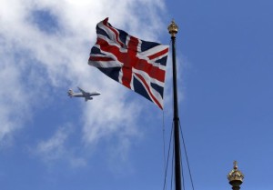 A British Airways passenger jet flies over the Union Flag above the Houses of Parliament in Westminster, in central London, Britain June 24, 2016.     REUTERS/Phil Noble