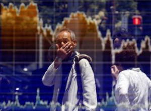 A man is reflected in an electronic board showing the graph of the recent fluctuations of the Tokyo Stock Price Index (TOPIX) outside a brokerage in Tokyo, Japan, June 27, 2016.  REUTERS/Toru Hanai
