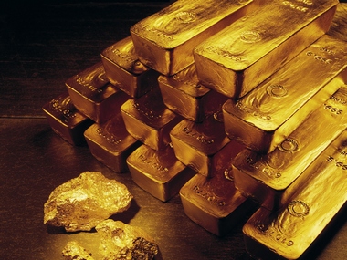 FILE - In this undated handout file photo from Newmont Mining Corporation, gold nuggets and bars are shown.  In December 2007, gold for about $840 an ounce. A little over a year later, it rose above $1,000 for the first time. It climbed gradually for the next two years. Then in March 2011, it began rocketing up. On Tuesday, Aug. 16, 2011, it traded at $1,788 an ounce, up 26 percent this year. (AP Photo/Newmont Mining, File )