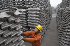 An employee checks aluminium ingots for export at Qingdao Port, Shandong province, in this March 14, 2010 file photo.  REUTERS/Stringer/Files
