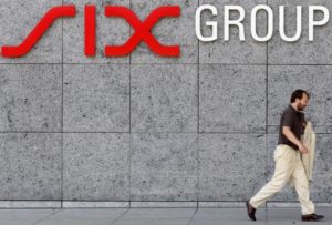 A man walks past a logo of SIX Group pictured at the entrance of the Swiss stock exchange in Zurich, August 2, 2011. REUTERS/Christian Hartmann
