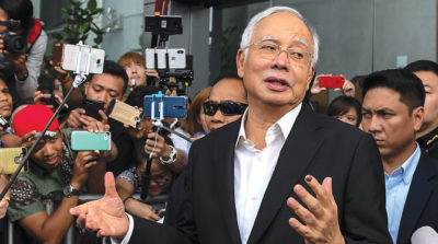 (FILES) This file photo taken on May 24, 2018 shows Malaysia's former prime minister Najib Razak speaks to the media after being questioned at the Malaysian Anti-Corruption Commission (MACC) office in Putrajaya. Malaysia had been a loyal partner in China's globe-spanning infrastructure drive but a new government is now pledging to review Beijing-backed projects, threatening key links in the much-vaunted initiative. - TO GO WITH AFP STORY:  Malaysia-China-investments-politics-diplomacy, FOCUS by Sam REEVES

 / AFP / Mohd RASFAN / TO GO WITH AFP STORY:  Malaysia-China-investments-politics-diplomacy, FOCUS by Sam REEVES
