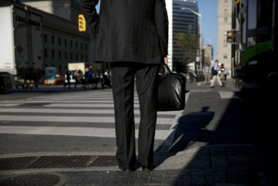 A commuter waits to cross a street in the financial district of Toronto, Ontario, Canada, on Wednesday, July 11, 2018. *** SECOND SENTENCE HERE***. Photographer: Brent Lewin/Bloomberg