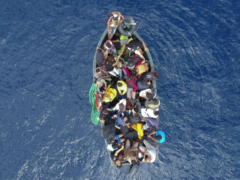 An aerial photo shows a boat carrying migrants stranded in the Strait of Gibraltar before being rescued by the Spanish Guardia Civil and the Salvamento Maritimo sea search and rescue agency that saw 157 migrants rescued on September 8, 2018.
While the overall number of migrants reaching Europe by sea is down from a peak in 2015, Spain has seen a steady increase in arrivals this year and has overtaken Italy as the preferred destination for people desperate to reach the continent. Over 33,000 migrants have arrived in Spain by sea and land so far this year, and 329 have died in the attempt, according to the International Organization for Migration. / AFP PHOTO / Marcos Moreno