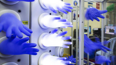 Latex gloves attached to an air compressor are inflated in the air-leak test room at a Top Glove Corp. factory in Setia Alam, Selangor, Malaysia, on Dec. 3, 2015. MUST CREDIT: Bloomberg photo by Charles Pertwee.
