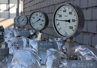 A manometer, a gauge for measuring gas, is seen on pipe work at the OAO Gazprom Neft oil refinery in Moscow, Russia, on Thursday, Sept. 20, 2012. OAO Gazprom Neft, the oil arm of Russia's state-run natural-gas producer, started operating a 3.2 billion-ruble ($100 million) bitumen processor at its Moscow refinery this month as it seeks to reduce pollution. Photographer: Andrey Rudakov/Bloomberg
