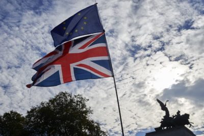 A demonstrator waves a Union flag and a European Union flag as they take part in a march calling for a People's Vote on the final Brexit deal, in central London on October 20, 2018. - Britons dreading life outside Europe gathered from all corners of the UK to London on Saturday to try to stop their country's looming breakup with the EU. (Photo by NIKLAS HALLE'N / AFP)