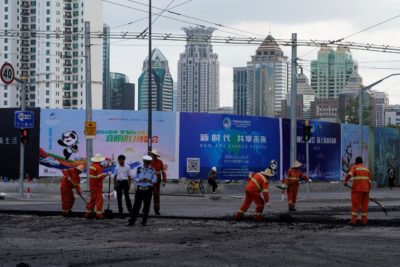Workers pave a road ahead of the China International Import Expo in Shanghai, China September 27, 2018.  REUTERS/Aly Song