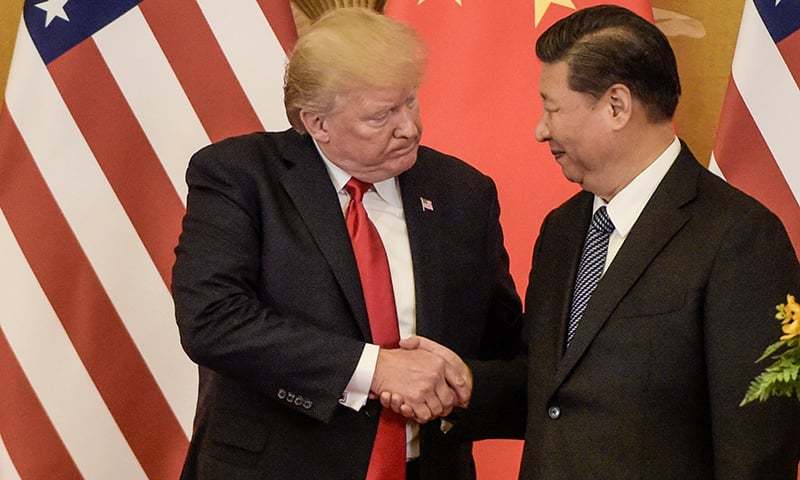(FILES) In this file photo taken on November 09, 2017, US President Donald Trump (L) shakes hand with China's President Xi Jinping at the end of a press conference at the Great Hall of the People in Beijing. - China said Monday, May 13, 2019 it will raise tariffs on $60 billion worth of US goods from June 1, in retaliation to the latest round of US tariff hikes and Washington's plans to target almost all Chinese imports. The announcement came after the latest round of US-China trade negotiations ended Friday, May 10, 2019 without a deal, and after Washington increased tariffs on $200 billion worth of Chinese goods. (Photo by Fred DUFOUR / AFP)