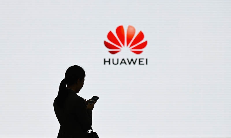 (FILES) In this file photo taken on March 6, 2019 a staff member of Huawei uses her mobile phone at the Huawei Digital Transformation Showcase in Shenzhen, China's Guangdong province. - US internet giant Google, whose Android mobile operating system powers most of the world's smartphones, said on May 19, 2019 it was beginning to cut ties with China's Huawei, which Washington considers a national security threat. (Photo by WANG ZHAO / AFP)