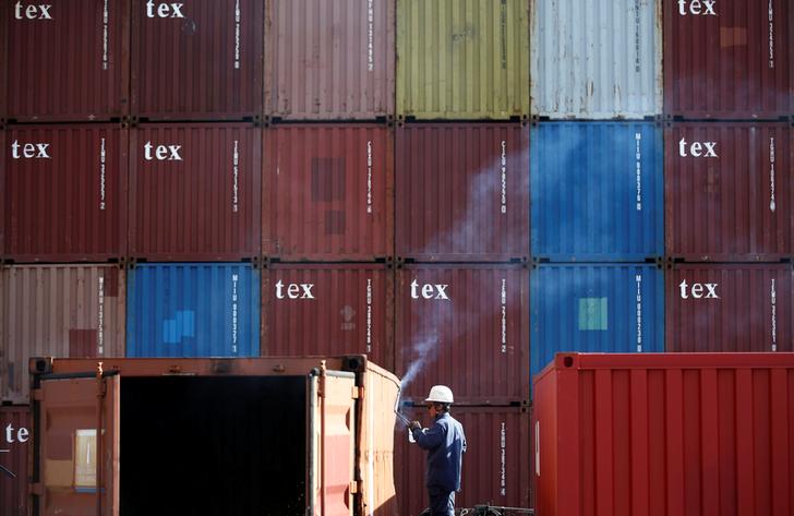 FILE PHOTO: A man repairs a container at an industrial port in Tokyo, Japan, February 22, 2019. REUTERS/Kim Kyung-hoon/File Photo