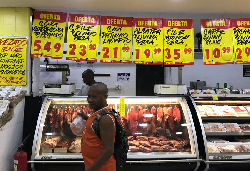 FILE PHOTO - A costumer buys meat at a supermarket in Rio de Janeiro, Brazil May 10, 2019. REUTERS/Pilar Olivares