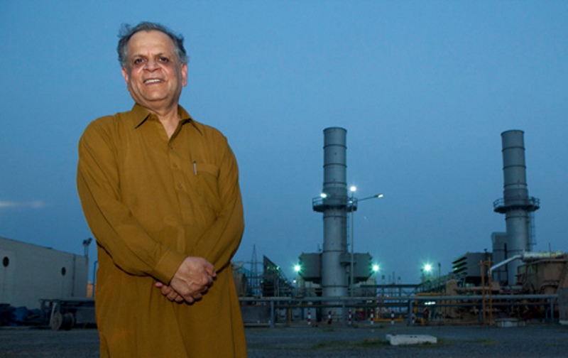 Igbal Ahmed of Associated Group poses in front of the Pakistan Power Resources 136MW BHIKHI Power Plant.
