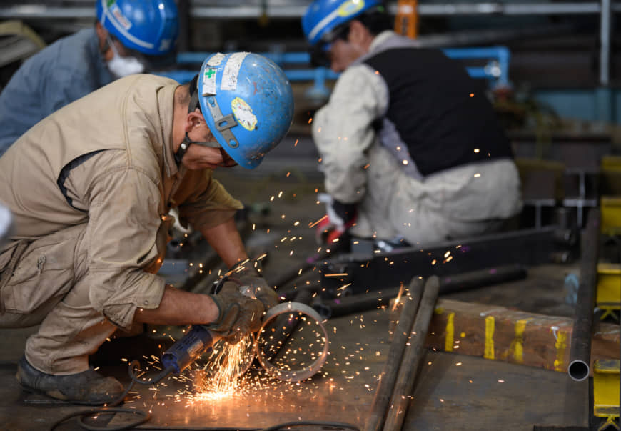 Sparks fly as a worker uses an angle grinder at a factory in the Keihin industrial area of Kawasaki, Kanagawa Prefecture, Japan, on Saturday, Sept. 28, 2019. Japans factory production dropped in August amid a global slowdown thats battered exports leaving the economy vulnerable as a sales tax hike taking effect this week threatens to crimp domestic demand. Photographer: Akio Kon/Bloomberg