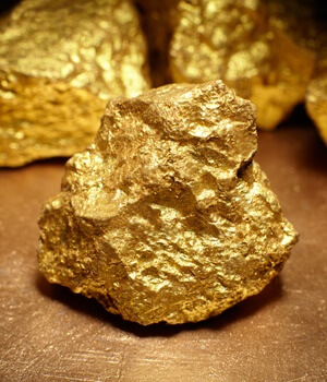 Closeup of big gold nugget, finance concept