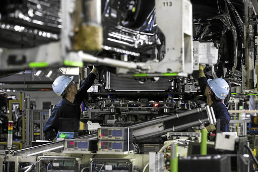 Toyota Motor Corp. employees work on the Crown vehicle production line at the company's Motomachi plant in Toyota City, Aichi, Japan, on Thursday, July 26, 2018. Toyota may stop importing some models into the U.S. if President Donald Trump raises vehicle tariffs, while other cars and trucks in showrooms will get more expensive, according to the automaker’s North American chief. Photographer: Shiho Fukada/Bloomberg