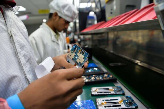 Workers assemble mobile phones at an Indian Lava phone manufacturer factory in Noida on August 22, 2019. (Photo by Sajjad HUSSAIN / AFP)