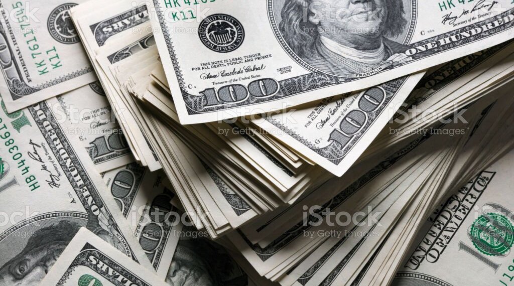 stack of one hundred dollars notes on dollars background