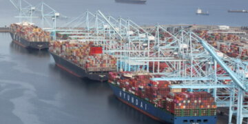 FILE PHOTO: Shipping containers are unloaded from ships at a container terminal at the Port of Long Beach-Port of Los Angeles complex, amid the coronavirus disease (COVID-19) pandemic, in Los Angeles, California, U.S., April 7, 2021. REUTERS/Lucy Nicholson