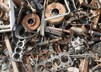 Old rusty corroded car parts in car scrapyard. Car recycling.Wrecking Machinery Parts wait for reused or to be a part for repair.